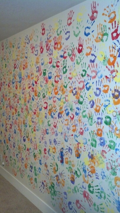 Wall of colorful handprints